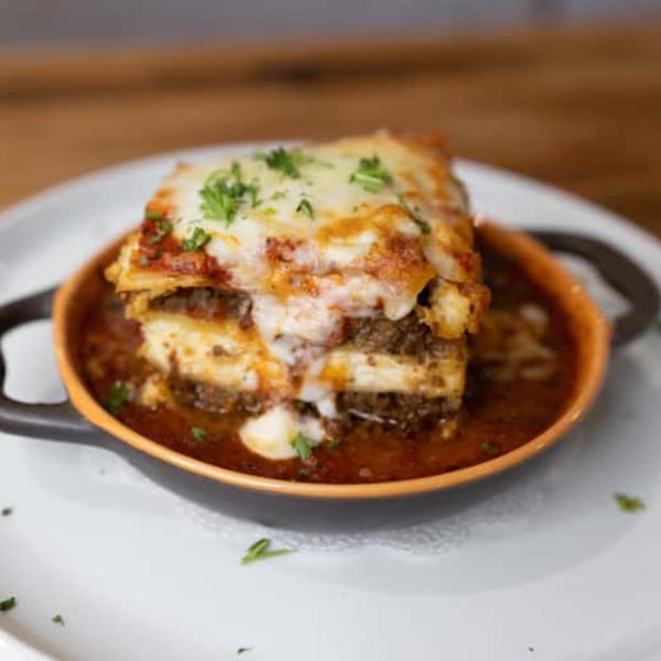 Andiamo Italian Grill's lasagna, a layered pasta dish with meat, cheese, and red sauce in a small bowl.