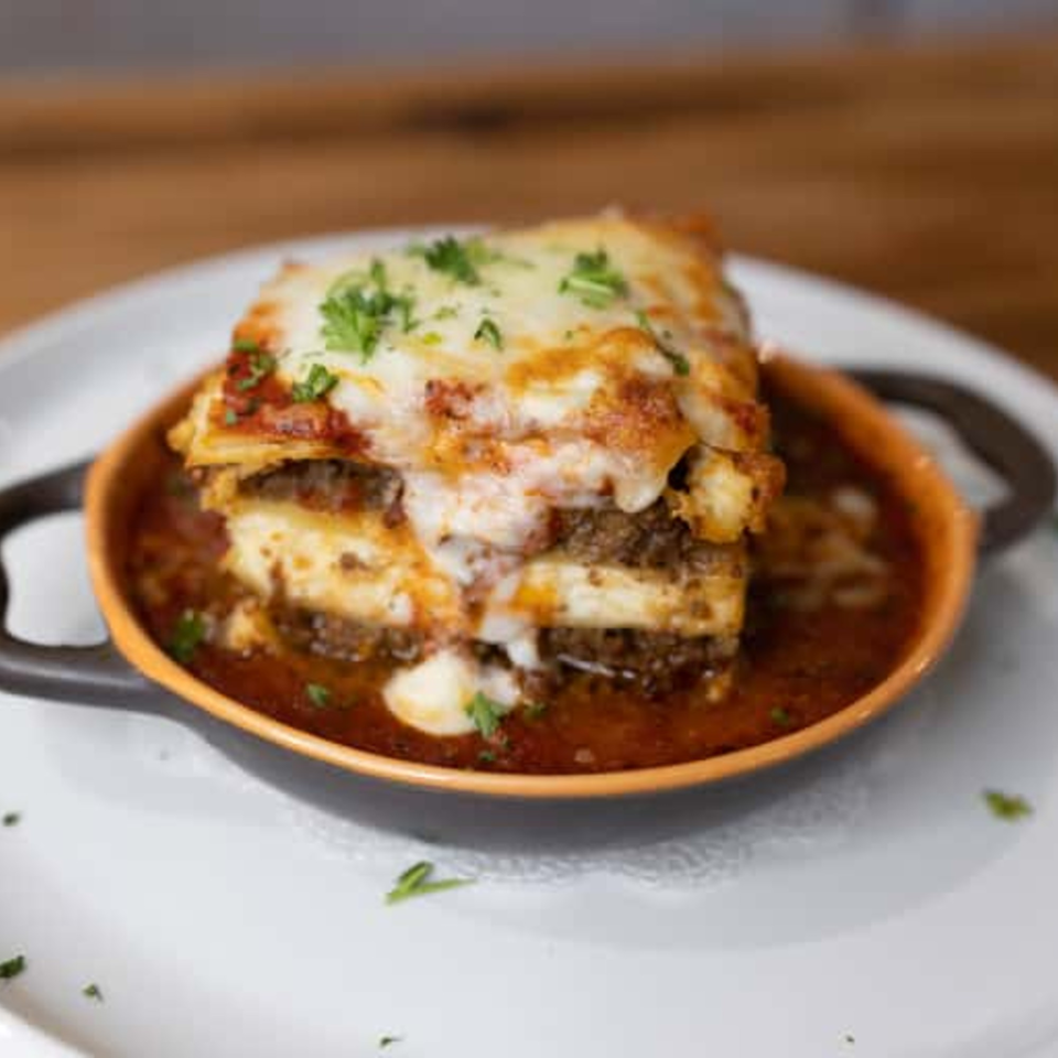Andiamo Italian Grill's lasagna, a layered pasta dish with meat, cheese, and red sauce in a small bowl.