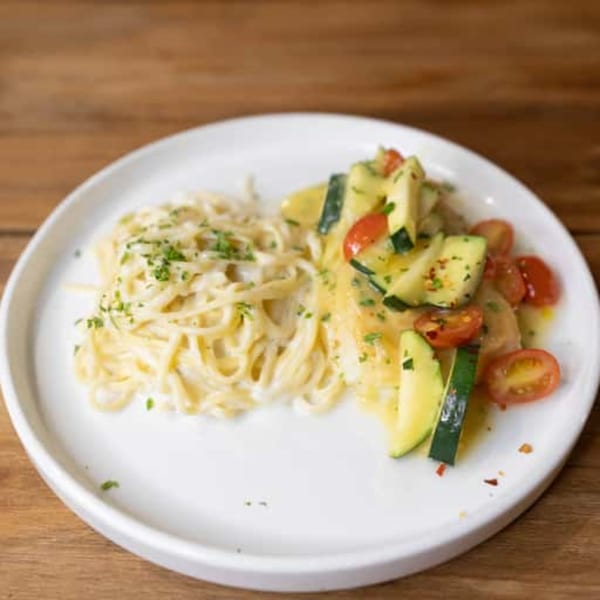Andiamo Italian Grill's creamy fettuccine alfredo with a side of sautéed zucchini and cherry tomatoes.